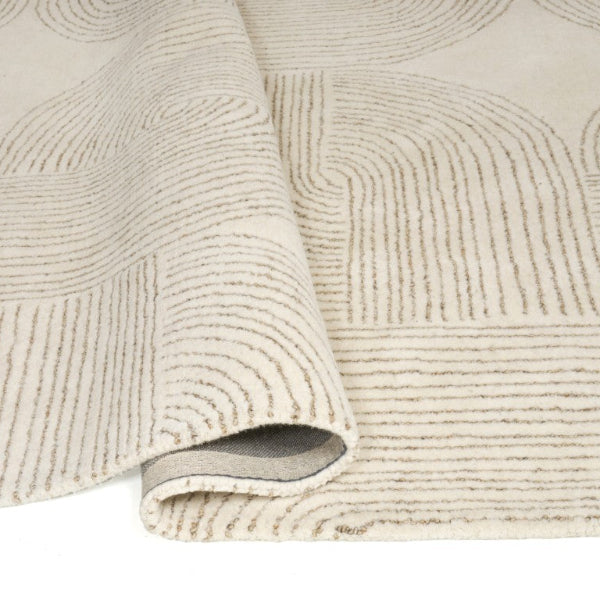 Textured beige rug with a subtle pattern on a white background