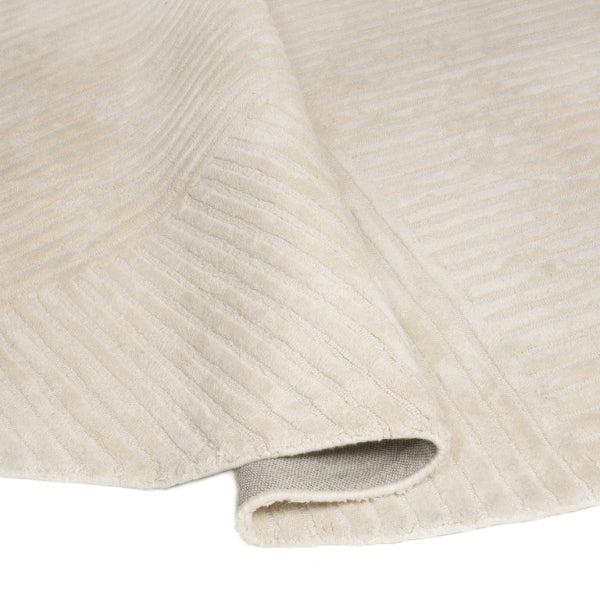 Close-up of textured beige fabric with a white background