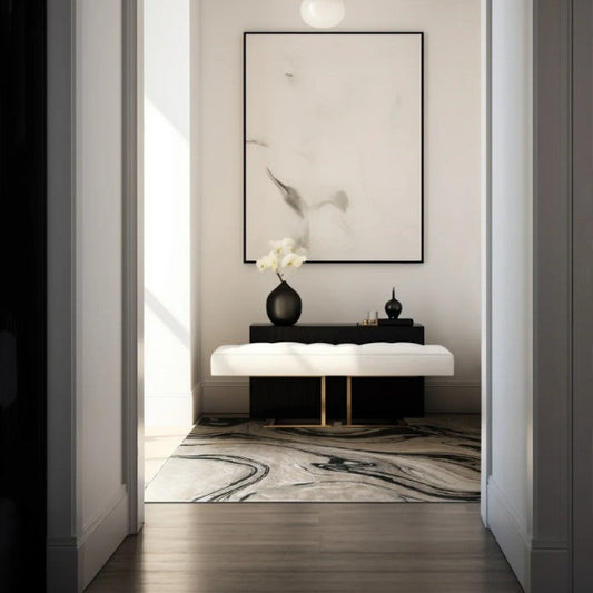 Modern interior design of a hallway with a light fixture, framed artwork, and decorative items.