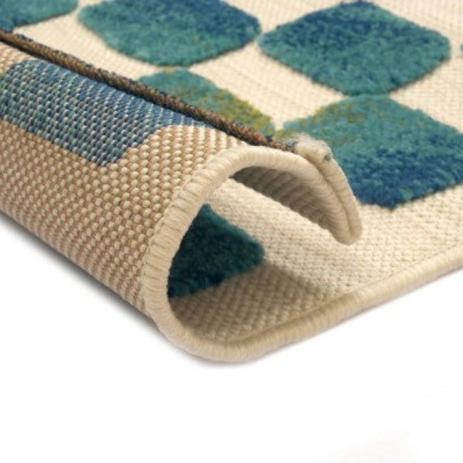 Close-up of a textured rug with geometric pattern on a white background