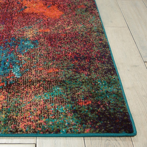 Multicolored abstract patterned rug on a light wooden floor