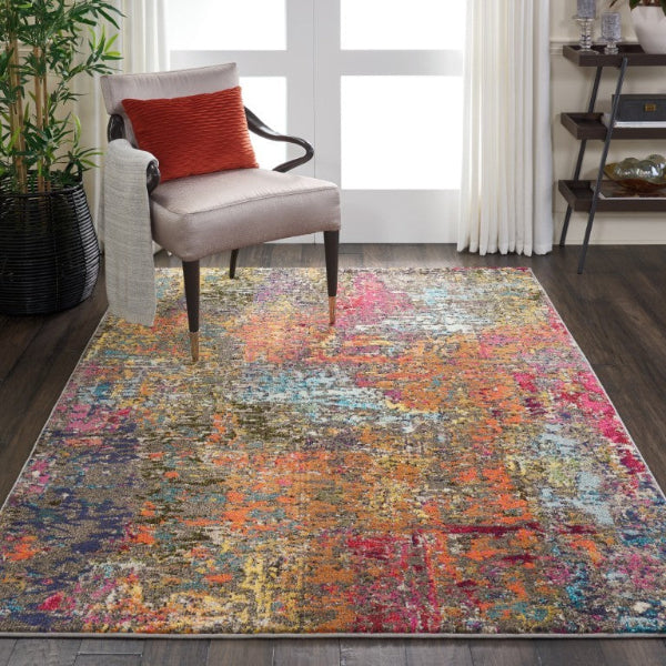 Multicolored area rug in a living room with a chair and plant.