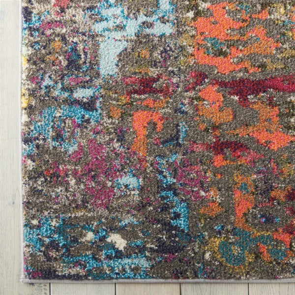 Multicolored abstract patterned rug on a wooden floor