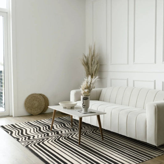 Modern living room with a white sofa, coffee table, and decorative items.