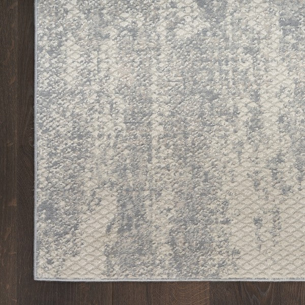 Textured grey rug on a wooden floor
