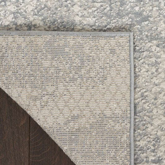 Textured grey rug on a wooden floor