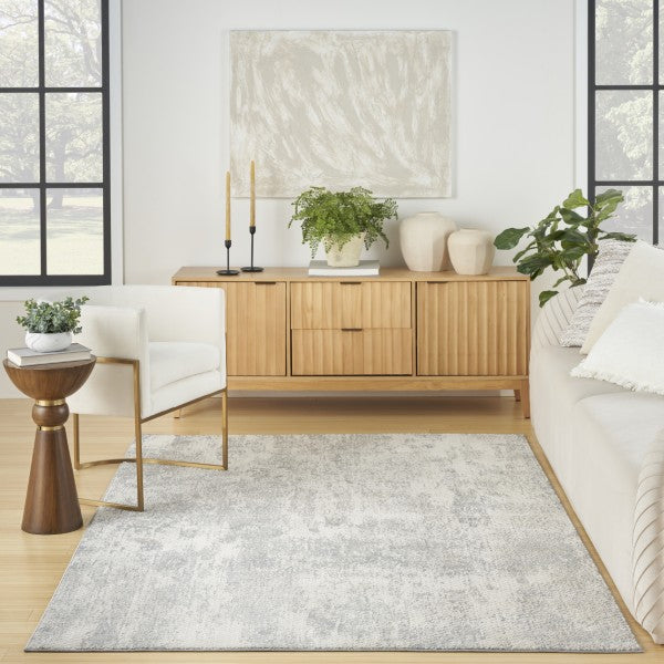 Living room with a wooden sideboard, white sofa, and decorative items.