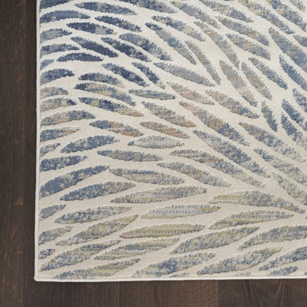 Close-up of a textured area rug with wavy pattern on a wooden floor.