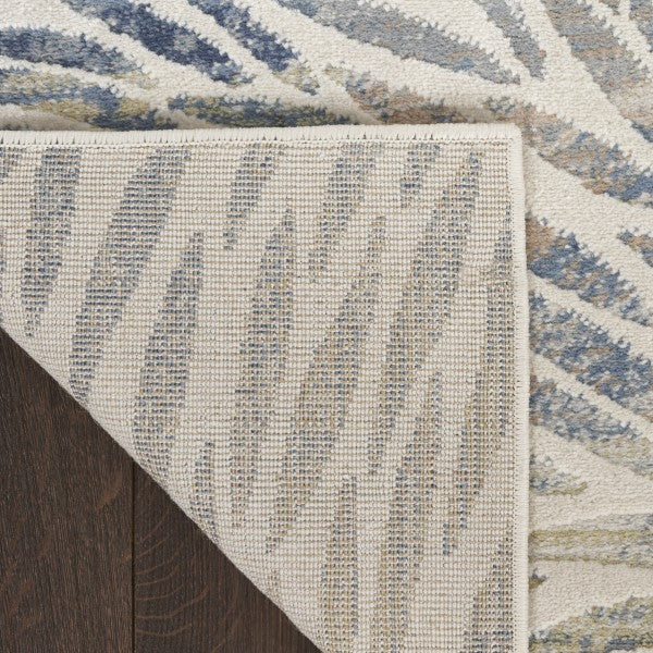 Close-up of a textured area rug with geometric pattern on a wooden floor.