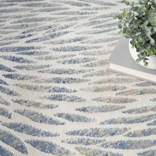 Textured rug with wavy pattern and a plant in the corner