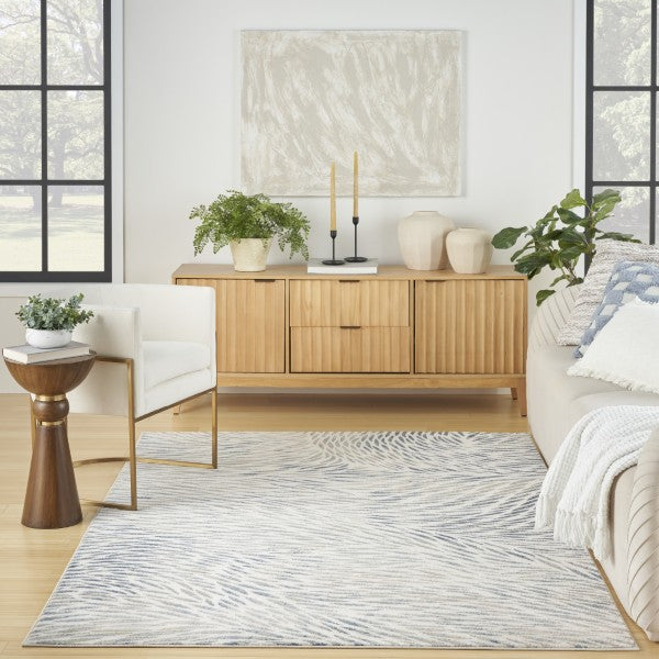 Living room with wooden sideboard, white sofa, and decorative plants.