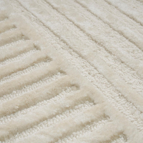 Close-up of a textured beige rug with wavy pattern