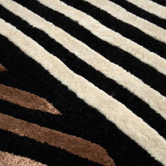 Close-up of a textured fabric with brown, black, and beige stripes.