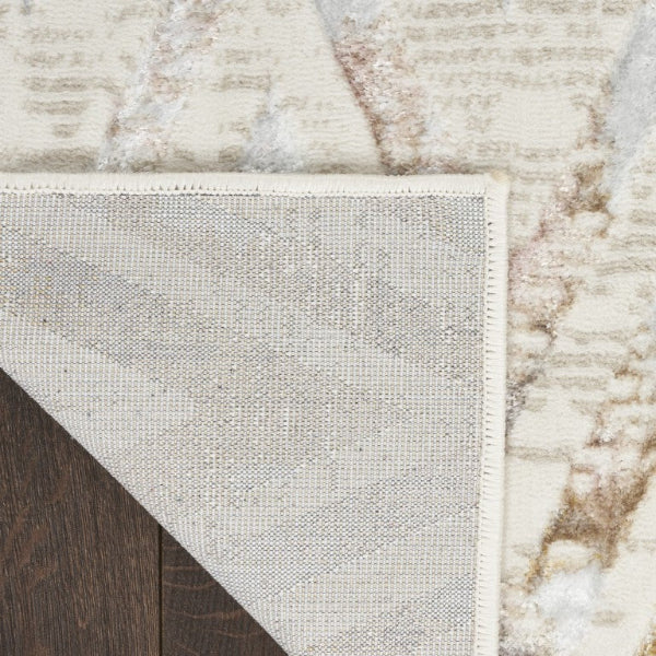 Close-up of a textured rug with a geometric pattern on a wooden floor.