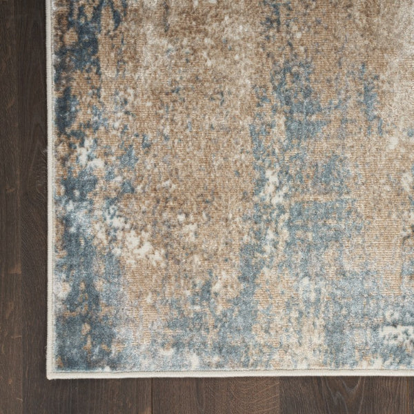 Textured area rug with a mix of brown, blue, and beige colors on a wooden floor.