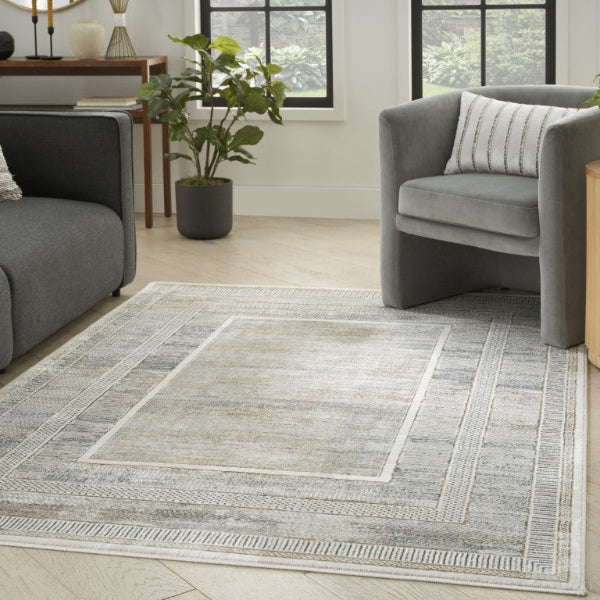 Living room with gray chairs and a patterned rug