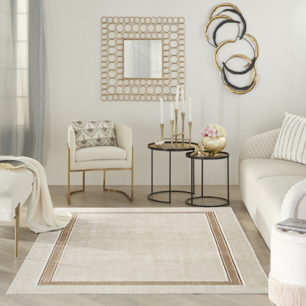 Modern living room with a beige rug, white sofa, and decorative wall art.