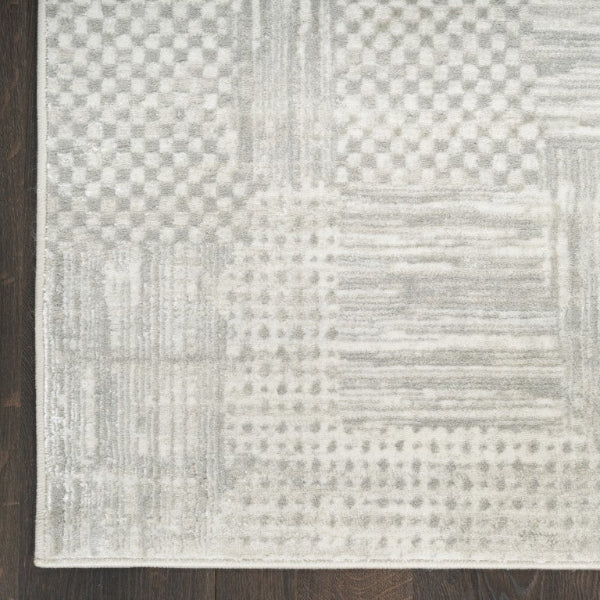 Textured area rug with geometric pattern on wooden floor