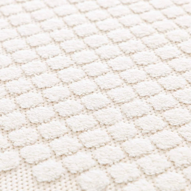 Close-up of a textured white fabric surface