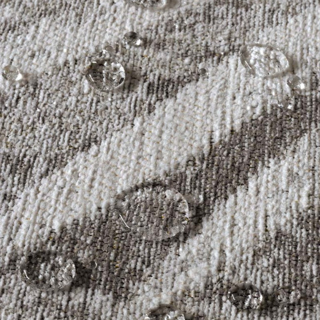 Close-up of water droplets on a textured fabric surface