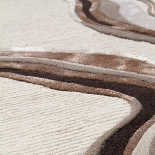 Close-up of a textured rug with wavy patterns in brown and beige.