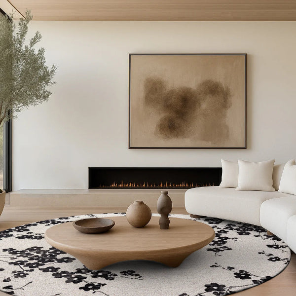Modern living room with white sofa, wooden coffee table, and abstract art on wall.