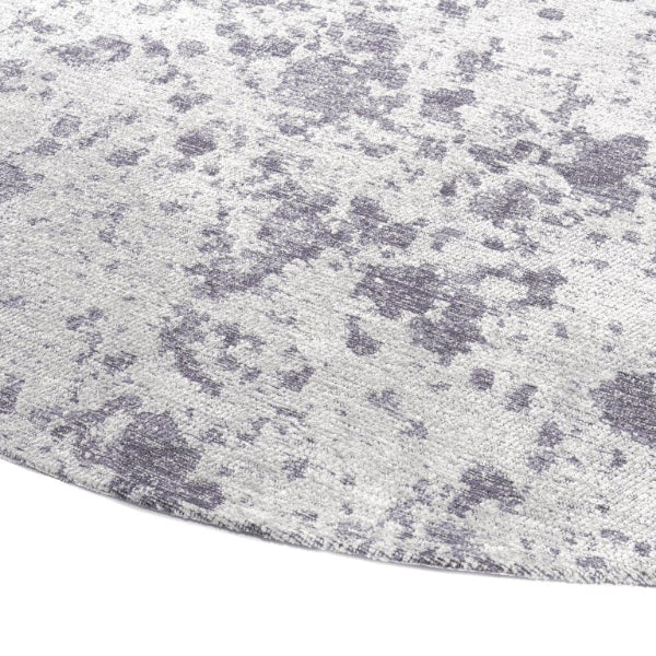 Close-up of a textured grey rug with a subtle pattern like the surface of the moon