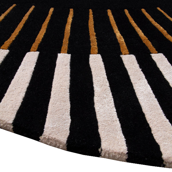 Close-up of a black and white striped rug with gold accents