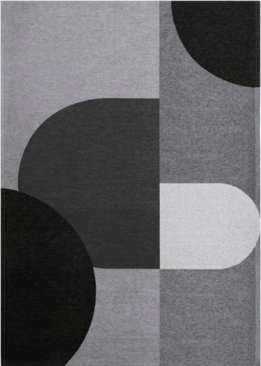 Rug with abstract pattern of black, gray, and white shapes