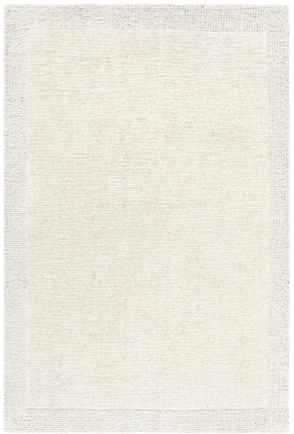 Beige area rug with a subtle pattern on a white background