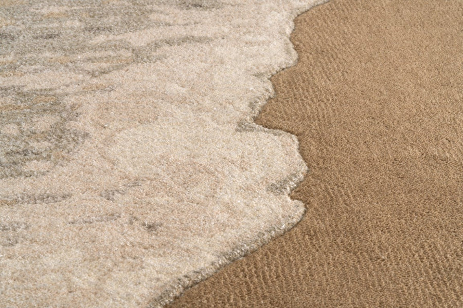 Close-up of sand and water meeting on a beach