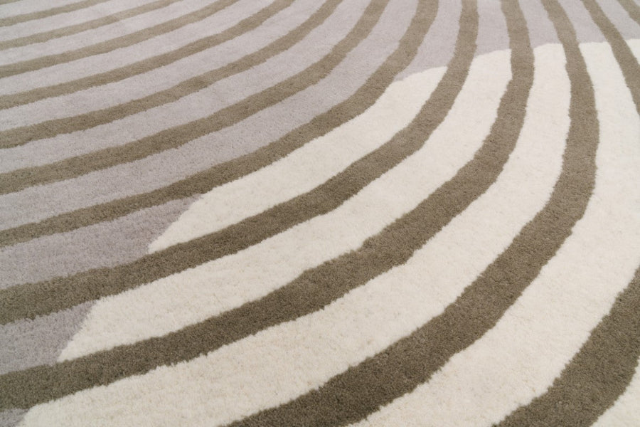 Close-up of a rug with wavy pattern in gray and white