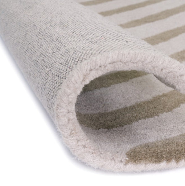 Close-up of a textured rug with a striped pattern on a white background