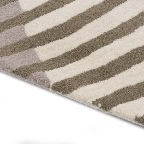 Close-up of a striped rug with brown and beige colors on a white background