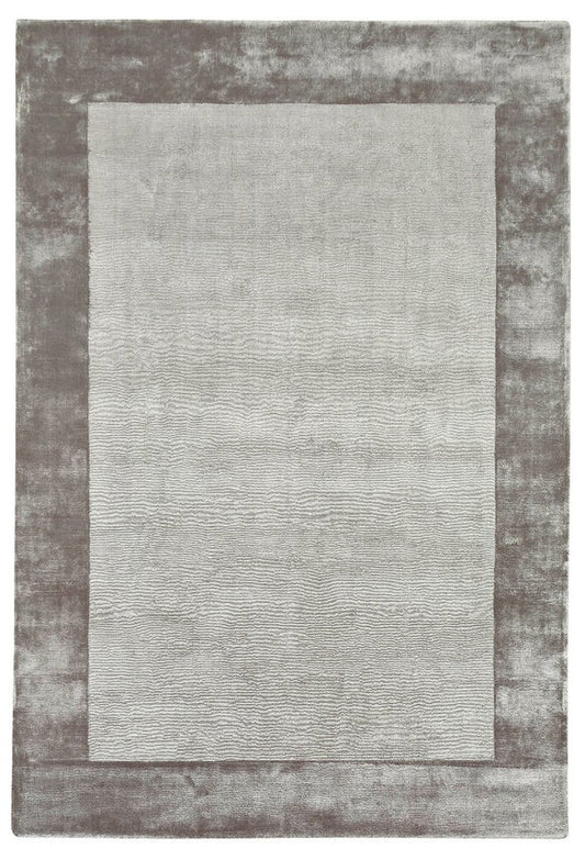 Rectangular rug with a textured border on a plain background