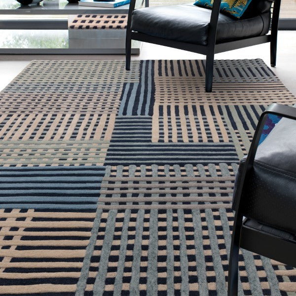 Asiatic Aspect Contemporary Designer Rug with geometric striped pattern in neutral tones under modern black leather chairs