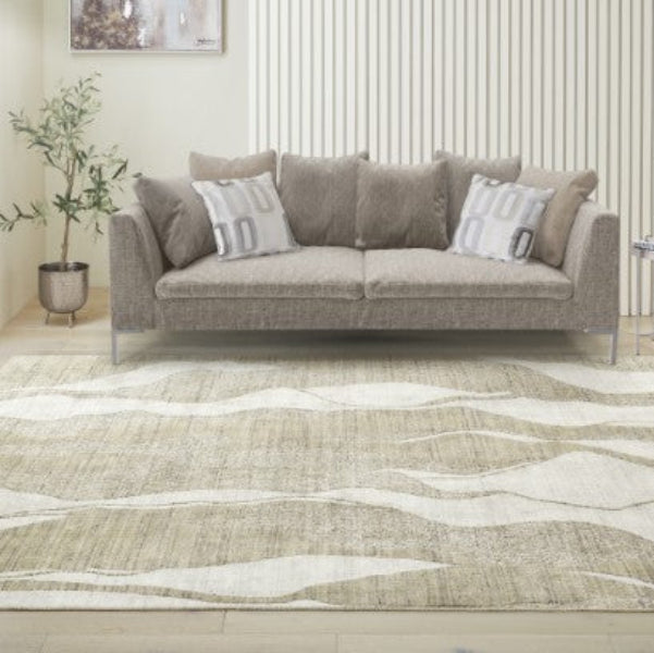 Concept Looms Dune Rug with wavy beige and cream pattern under a grey sofa in a modern living room