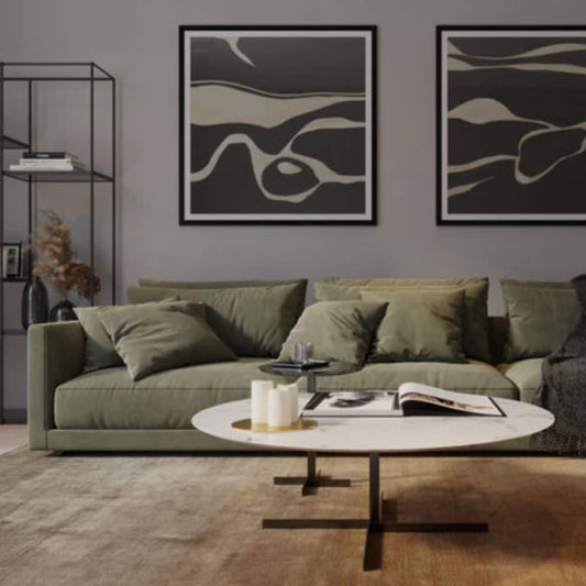 Modern living room with a green sofa, abstract art, and a coffee table.