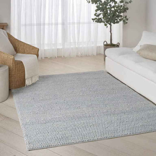 The DKNY Pure Knots Rug Collection in light grey, perfect for modern living areas and enhancing comfort