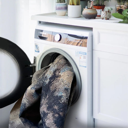 Laundry room with washing machine, dryer, and decorative plants.