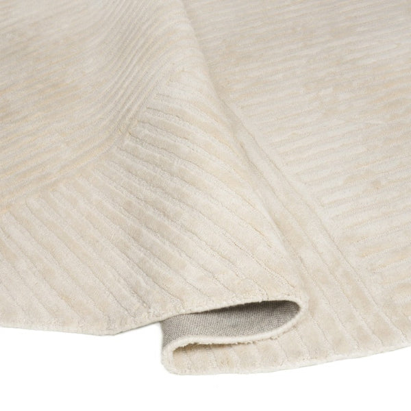 Close-up of textured beige fabric with a subtle pattern
