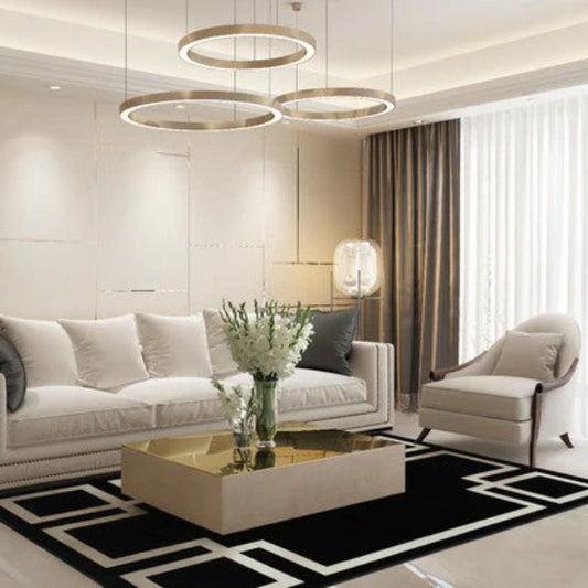 Modern living room with white sofa, coffee table, and armchair.