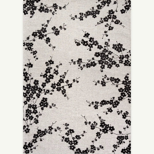 Floral patterned rug with black flowers on a light gray background
