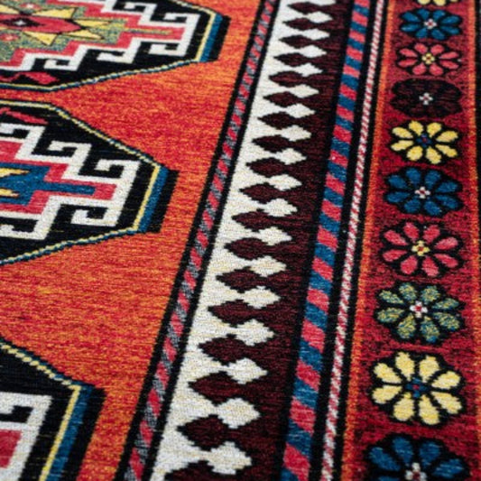 Close-up of Louis De Poortere Antalia rug showing vibrant red tones and intricate geometric and floral patterns