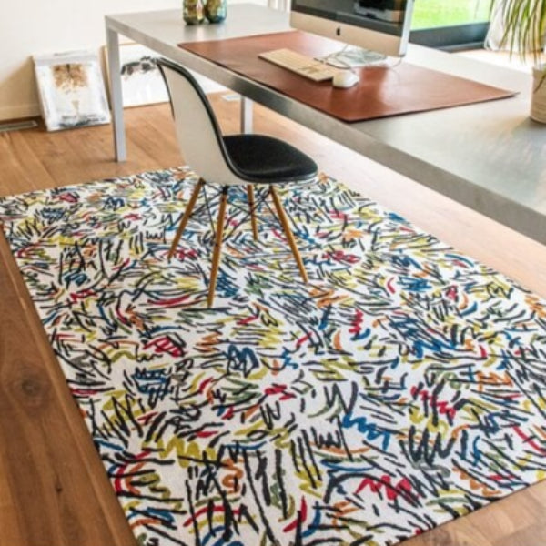 Louis De Poortere Dora and Graffito rug with colourful abstract pattern in a modern office setting
