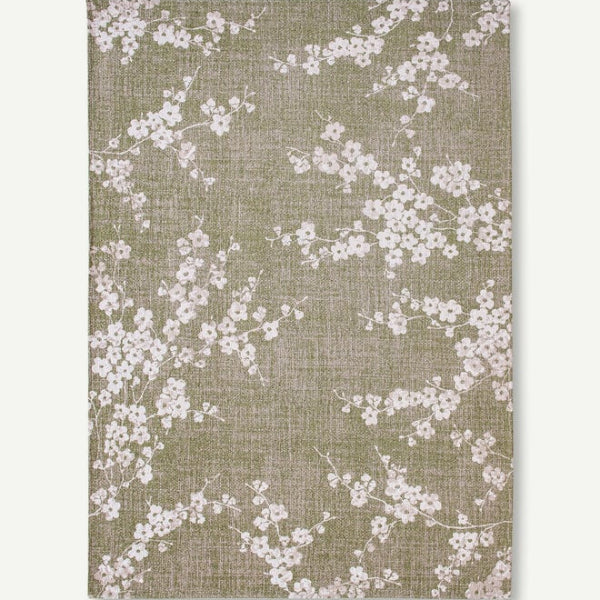 Louis De Poortere Sakura rug luxury design with delicate white floral patterns on a muted green background