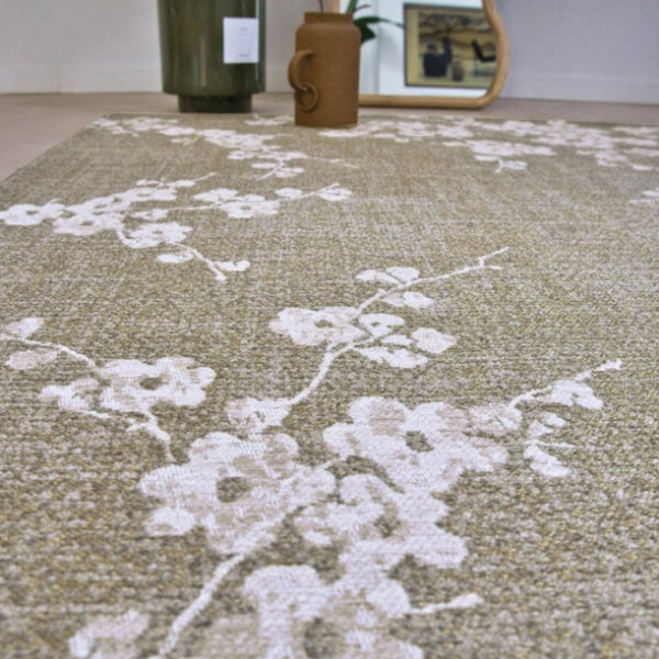 Louis De Poortere Sakura rug with delicate white floral pattern on a soft beige background luxury floor decor
