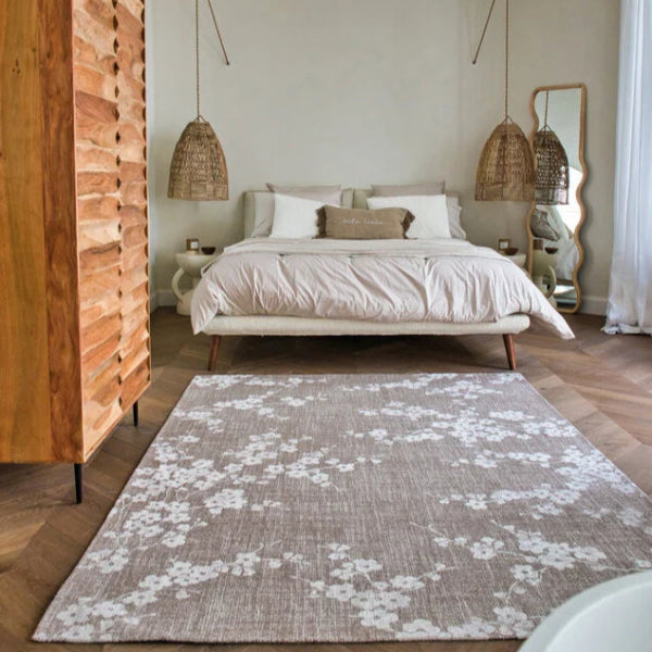 Louis De Poortere Sakura rug in neutral tones with floral pattern placed in stylish bedroom