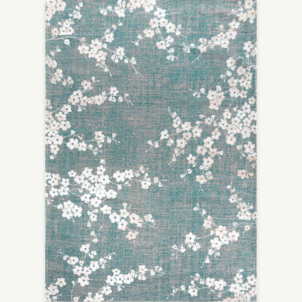 Louis De Poortere Sakura rug with delicate white floral pattern on turquoise background luxury rug
