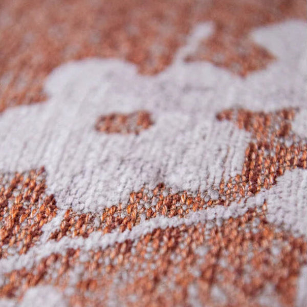 Close-up texture of Louis De Poortere Sakura rug showing detailed floral pattern in soft pink and brown shades